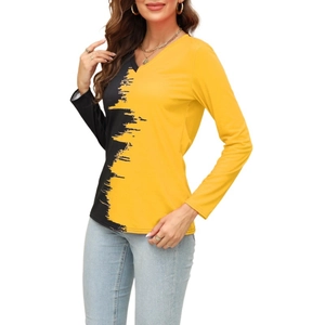 Detail of yellow and black V-neck top showing artistic brushstroke texture and stitching