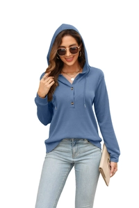 Close-up of blue waffle knit hoodie with wooden buttons and drawstring detail