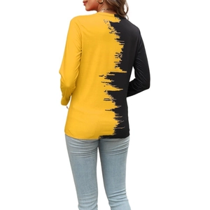 Detail view of contrast yellow and black splicing design on the back of the long sleeve top