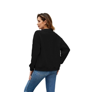 Detail view of the back and side cut of a casual black long-sleeve knit sweatshirt