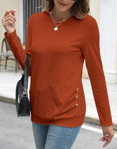 Close-up of ribbed knit texture and amber decorative buttons on caramel long sleeve shirt