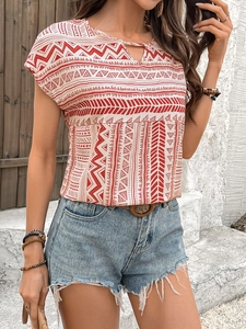 Detail of bohemian geometric print on women shirt with V-neckline and vibrant red patterns