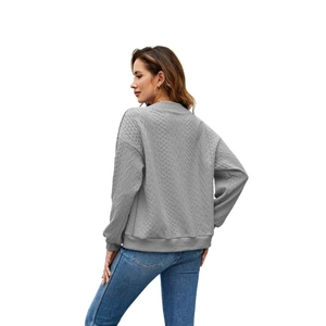 Detail of grey cable knit zip hoodie featuring intricate diamond patterns on the back