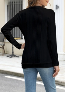 Outdoor back view of a slim-fit black ribbed long-sleeve T-shirt with a round neckline