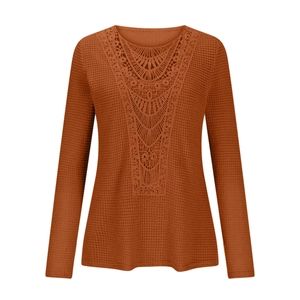 Close-up of rust red waffle knit shirt with intricate lace V-neckline floral embroidery