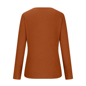 Close-up of caramel waffle knit texture and stitching on long sleeve top for women