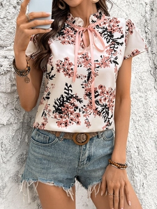 Women's short sleeve floral chiffon shirt with ruffled collar and pink bow tie detail