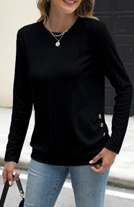 Detail shot of black ribbed knit top showing three gold buttons on the side hem