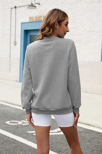 Detailed back view of light gray knit hoodie showing cable and diamond texture patterns