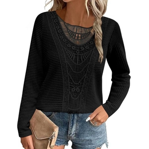 Detail of hollow lace neckline and textured waffle knit fabric on black long-sleeve top