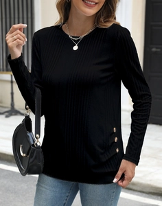 Detail of ribbed knit texture and decorative amber buttons on a black long sleeve tee