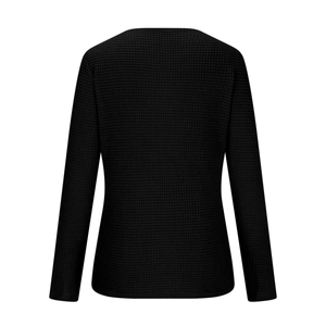 Detailed back view of black waffle knit long sleeve top with textured fabric surface