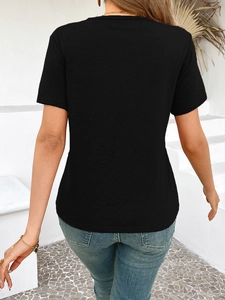 Rear view of a slim fit black short sleeve T-shirt paired with blue denim jeans