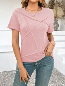 Detail view of pink cotton t-shirt featuring unique criss-cross decorative stitching