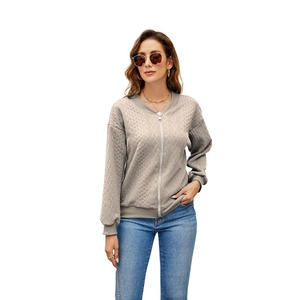 Detailed view of women's oatmeal cable knit zip-up cardigan with ribbed stand collar