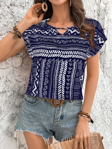 Detail of blue geometric print top featuring a keyhole neckline and tribal pattern design