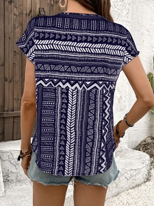 Back view of bohemian navy blouse with white geometric patterns in outdoor setting