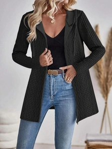 Close-up of black hooded cardigan with classic cable knit texture and metal zipper detail