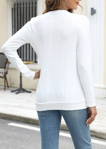 Detail of white ribbed knit long sleeve tee with crew neck and button accents