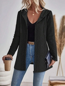 Close-up of black cable knit hoodie jacket with zipper closure and chunky texture