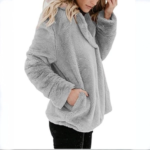 Detail shot of the plush faux fur texture and side pocket on this grey winter cardigan