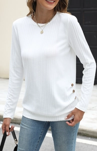 Detailed view of white ribbed knit texture and decorative brown buttons on the side