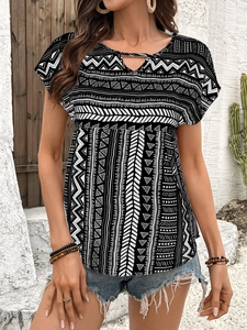 Detail of bohemian geometric print women's short sleeve top with hollow-out neckline design