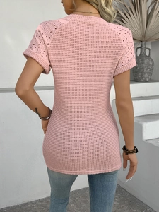 Detail of pink slim fit top showing delicate hollow-out lace texture on back and sleeves