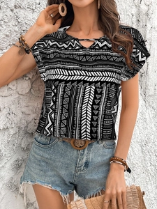 Detail of geometric tribal print women blouse with neckline cutout and soft texture
