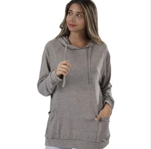 Detail of grey hooded sweatshirt featuring side pockets and adjustable drawstrings