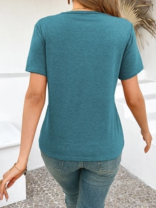 Back view of a blue short-sleeved t-shirt with a textured finish on white stairs
