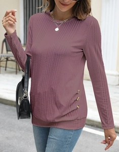 Detail of ribbed knit fabric on a buttoned long sleeve top with textured finish