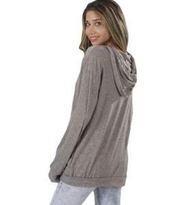 Rear view of grey long sleeve hoodie showing back cut and hood details on model