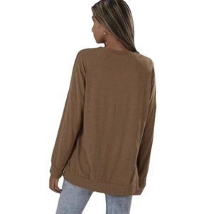 Back view of a casual loose fit crewneck long sleeve top for women in warm brown