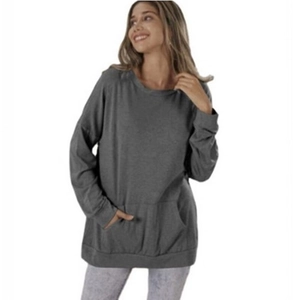 Detail of loose fit dark grey sweatshirt featuring a kangaroo pocket and ribbed cuffs