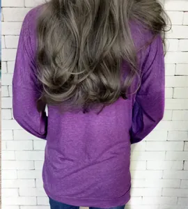Rear view of a dark purple long-sleeved loose top with dropped shoulders and back seam detail