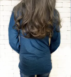 Back view of a loose dark blue long-sleeve top with drop shoulders and ribbed hem details