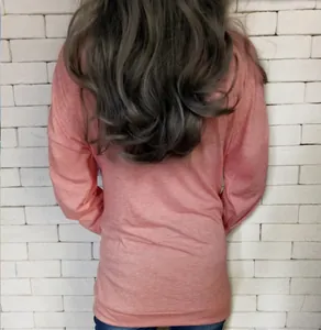 Detailed back view of a pink crewneck long sleeve top with functional pockets