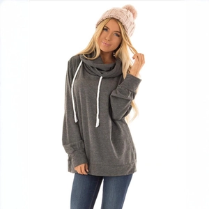 Detail of the dark gray hoodie showing thick white drawstrings and large collar texture
