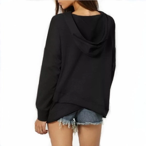 Back view of black oversized hoodie with drop shoulders and an asymmetrical hemline