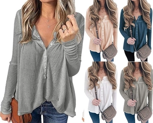 Close-up of waffle knit texture and buttoned V-neck on loose-fit long-sleeve Henley tops