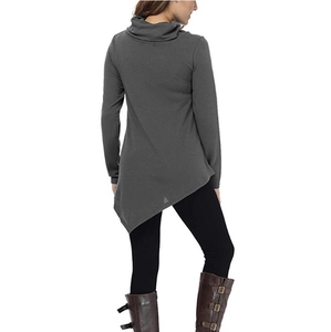 Detail view of dark grey turtleneck top featuring an asymmetrical hem and slim fit sleeves