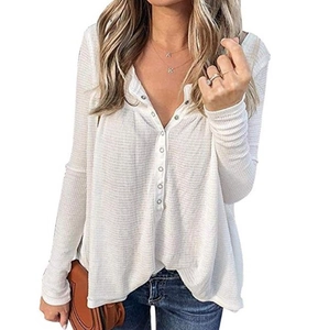 Detailed view of white waffle knit top showing buttoned Henley neckline and honeycomb texture