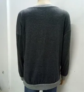Detail of grey crewneck top featuring light grey ribbed cuffs and hem on the back view