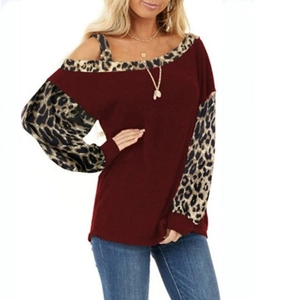 Detail of burgundy off-shoulder top with leopard print cuffs and asymmetric neckline