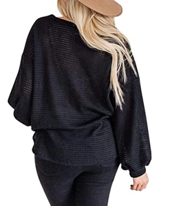 Detail of black waffle knit texture on back of an oversized lantern sleeve casual top