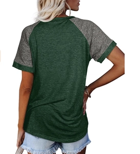Detail view of women's raglan short sleeve T-shirt with green body and grey sleeves