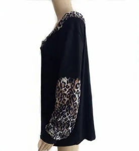 Detail of loose leopard print patchwork sleeve on black long sleeve tunic top