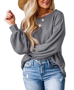 Close-up of grey waffle knit long sleeve top showing textured fabric and lantern sleeve details