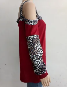 Detail of cold-shoulder leopard print patchwork on burgundy long sleeve top